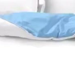 a bed with a blue and white comforter and pillows