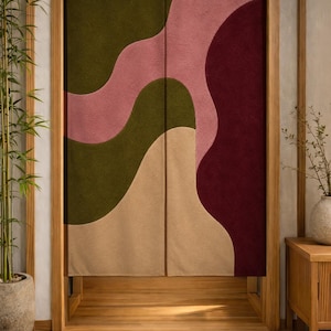 May include: A decorative door curtain with a modern abstract design. The curtain features flowing shapes in olive green, dusty rose, burgundy, and tan. The curtain is framed by a wooden door frame and is hanging in a room with a bamboo plant.