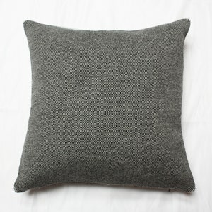 May include: A gray square pillow with a textured fabric.