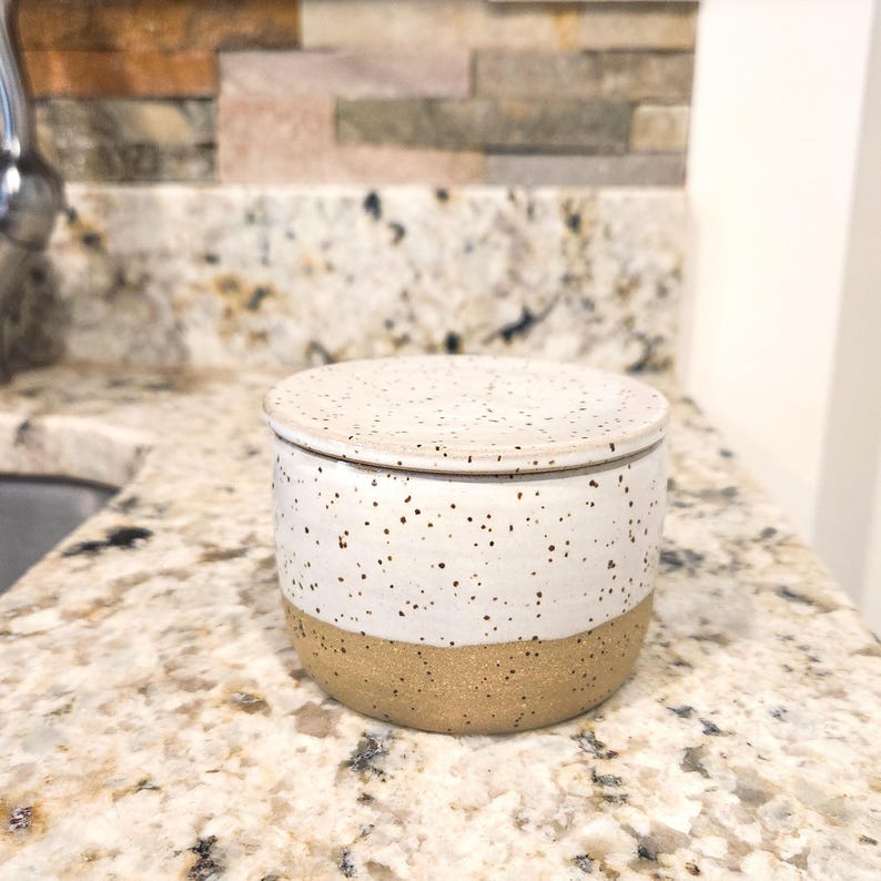 The neutral color of the handmade butter keeper is suitable for many kitchen design styles, including farmhouse kitchens.