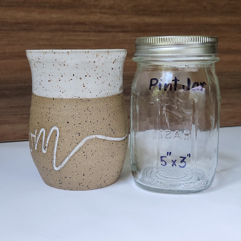 The mug is about the size of a pint jar.  Volume is 16 - 18 ounces.  This allows the drinker to add all their favorite  mix-ins to their coffee, tea, or beverage of choice.