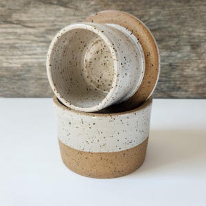 The interior butter cup is fully glazed in white for easy cleaning.  The individually thrown butter keeper holds one stick of butter.