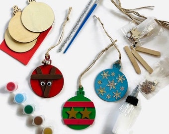 May include: A Christmas ornament craft kit with wooden ornaments, paint, glitter, twine, and other embellishments.
