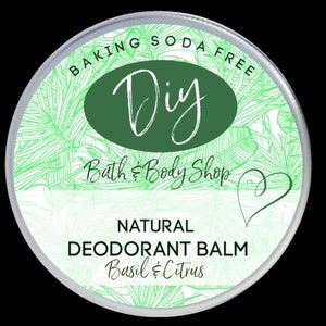 May include: A white round container with a green and white label. The label says "Baking Soda Free DIY Bath & Body Shop" and "Natural Deodorant Balm Basil & Citrus".