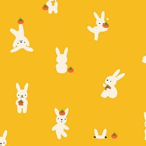 May include: A mustard yellow fabric featuring a repeating pattern of small white rabbits in various poses, including reading, sleeping, and holding red tomatoes. A black ruler at the bottom shows measurements from 1 to 7 cm.