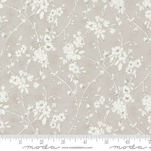 May include: A white floral pattern on a light grey background. The pattern features delicate white flowers and branches. The fabric is a cotton blend and is ideal for quilting, crafts, and home decor.