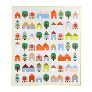 May include: A colourful quilt with a geometric pattern of houses, trees, and flowers. The quilt is made up of squares in shades of orange, yellow, green, blue, and pink.
