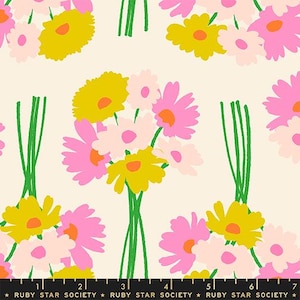 May include: A fabric pattern featuring repeating bouquets of stylised flowers in shades of yellow, light pink, and bright pink with green stems on a cream background. A black ruler at the bottom shows measurements in centimetres.