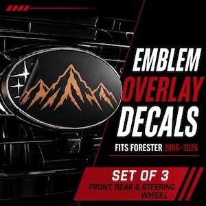 May include: A set of three black emblem overlay decals for a vehicle, featuring a copper-coloured mountain range graphic and a star icon. The text reads: EMBLEM OVERLAY DECALS FITS FORESTER 2006-2026 SET OF 3 FRONT, REAR & STEERING WHEEL.