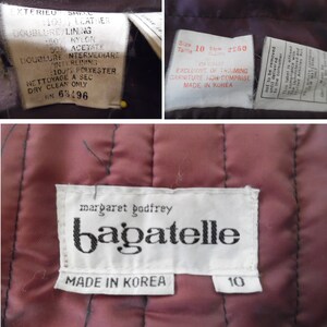 Op de afbeelding: Een close-up van een bordeauxrood gewatteerd jack met een wit label waarop "margaret godfrey bagatelle" en "Made in Korea" staat. Het label heeft ook een maatlabel met de tekst "10".