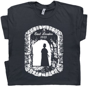 May include: A dark gray t-shirt with a white graphic of a silhouette of a person walking through an archway. The archway has a sign that reads "East London 1888".