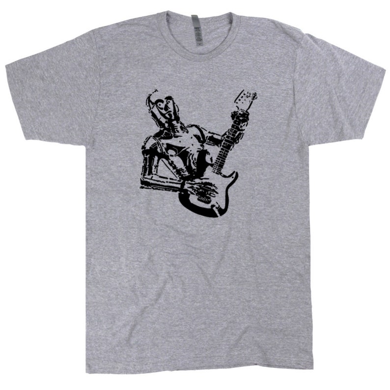 May include: A gray t-shirt with a black silhouette of a robot playing an electric guitar.