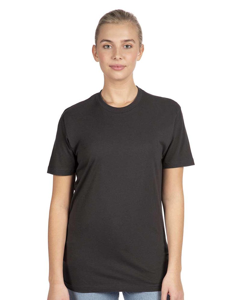 May include: A charcoal gray crew neck t-shirt. The short-sleeved shirt is made of a soft material and is worn by a person. The shirt has a classic, simple design.