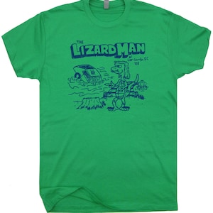 May include: Green t-shirt with a blue graphic of a cartoon lizard with the text "The Lizard Man of Lee County, SC '88"