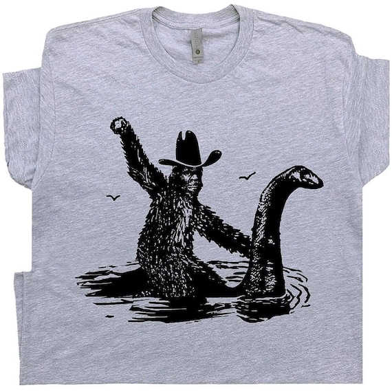 Funny Bigfoot T Shirt Cool Loch Ness Monster Shirt Cool Big Foot Tshirt for Men Women Boys Riding Nessie Cryptid Shirt Sasquatch Graphic Tee
