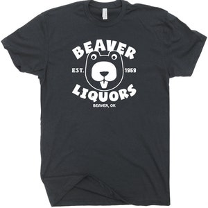 May include: A black t-shirt with a white graphic of a beaver with the text "Beaver Liquors" in a circle around it. The text "Est. 1969" is above the beaver and the text "Beaver, OK" is below the beaver.
