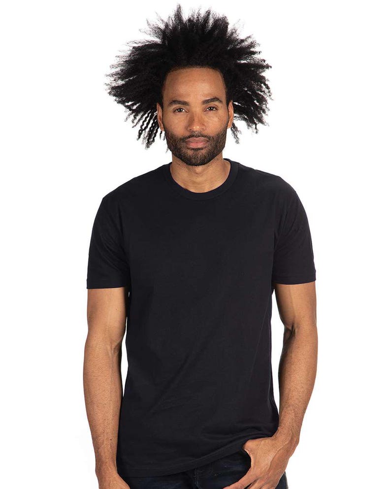 May include: A black crew neck t-shirt. The short-sleeved shirt is made of a soft material. The model has dark hair and a beard. The background is white.