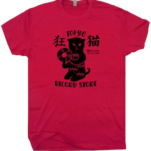 May include: Red t-shirt with a black graphic of a cat holding a vinyl record. The graphic says "Tokyo 猫 Record Store" and "猫 333" in Japanese.