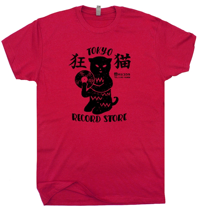 May include: Red t-shirt with a black graphic of a cat holding a vinyl record. The graphic says "Tokyo 猫 Record Store" and "猫 333" in Japanese.