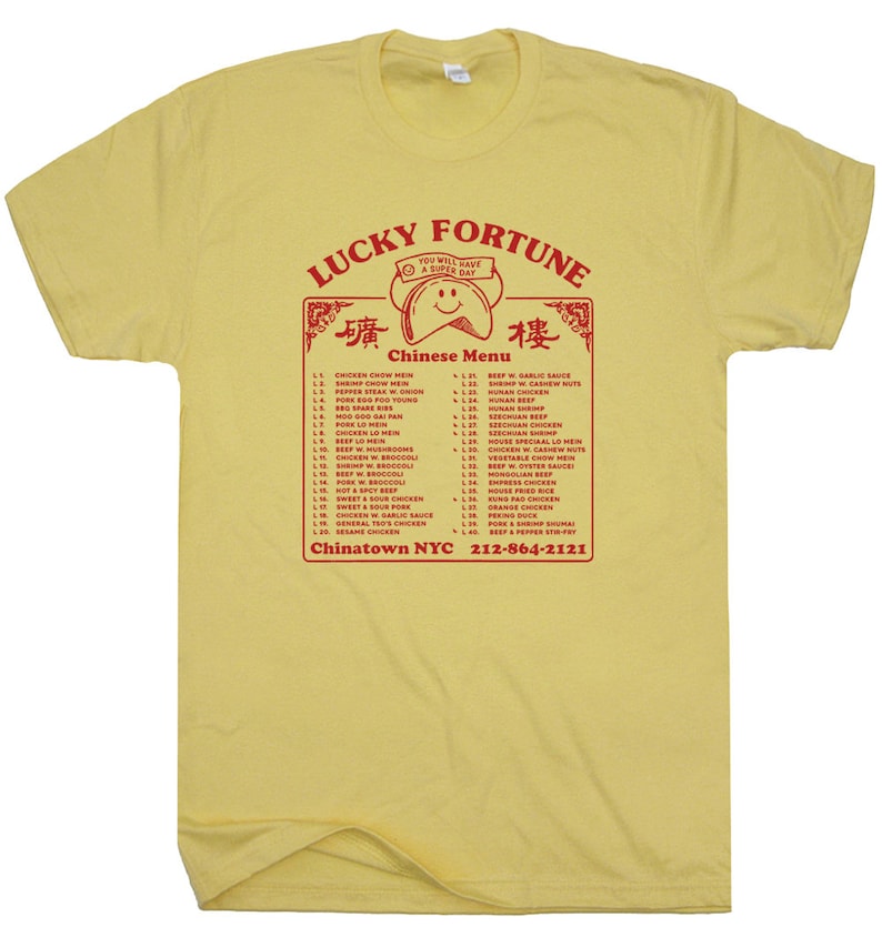 May include: A yellow t-shirt with a red graphic of a Chinese restaurant menu. The menu includes a variety of dishes, such as chicken chow mein, pepper steak with onion, and pork egg foo young. The text "Lucky Fortune" is at the top of the menu, and the text "Chinatown NYC 212-864-2121" is at the bottom.