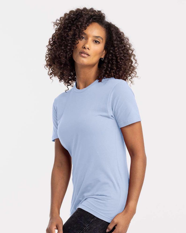 Puede incluir: Una camiseta azul claro con cuello redondo. La camiseta de manga corta est&aacute; hecha de un material suave. La modelo lleva vaqueros negros. La camiseta es de color liso y tiene un dise&ntilde;o cl&aacute;sico y sencillo.