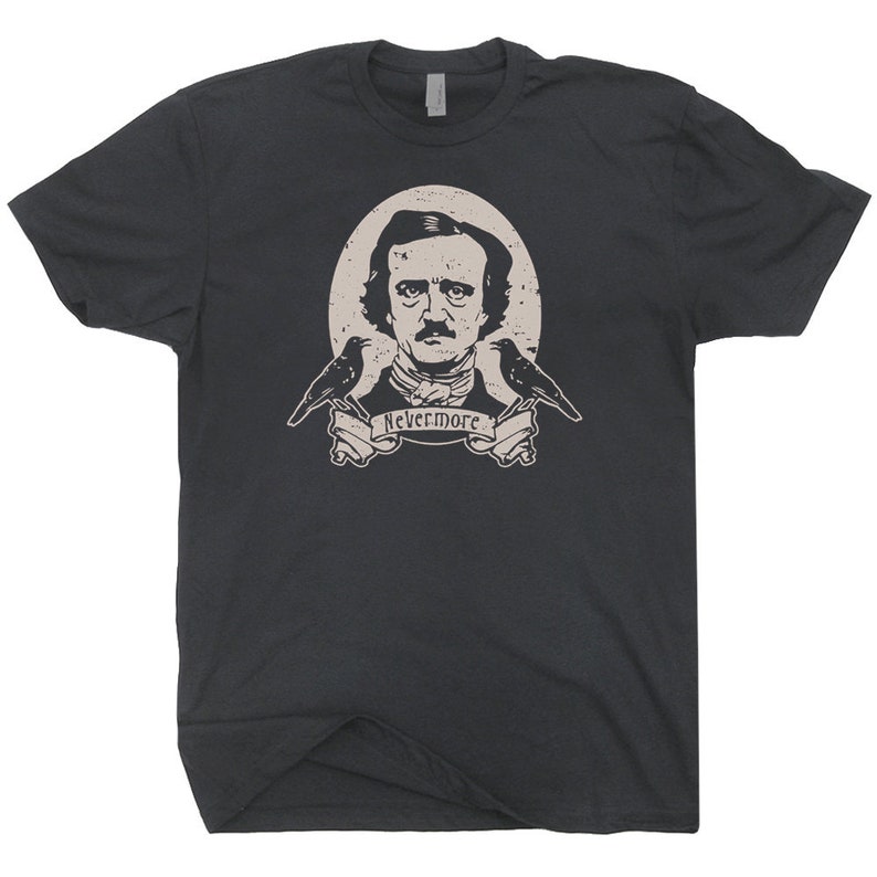 May include: A dark grey t-shirt featuring a vintage-style illustration of Edgar Allan Poe, two ravens, and the text "Nevermore".