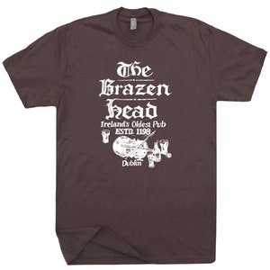 May include: A brown t-shirt with a white graphic of The Brazen Head, Ireland's Oldest Pub, established in 1198, in Dublin.