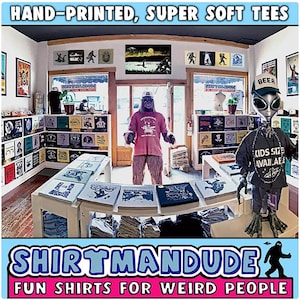 May include: A shop called "Shirtmandu" with the tagline "Fun Shirts for Weird People" sells hand-printed, super soft t-shirts. The shop is decorated with a variety of t-shirts, posters, and other items. There are two figures in the shop, one dressed as a Bigfoot and the other as an alien.