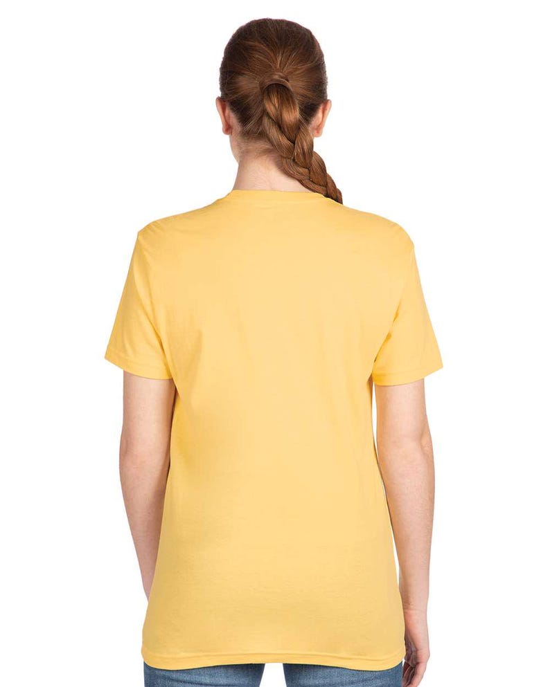 May include: A solid yellow t-shirt with short sleeves. The back view of the shirt is shown, with the neckline and shoulders visible. The shirt is made of a soft material and is a basic, everyday garment.