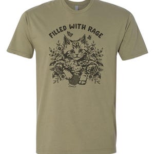May include: A green t-shirt with a black and white illustration of a cat with the text "Filled with Rage".