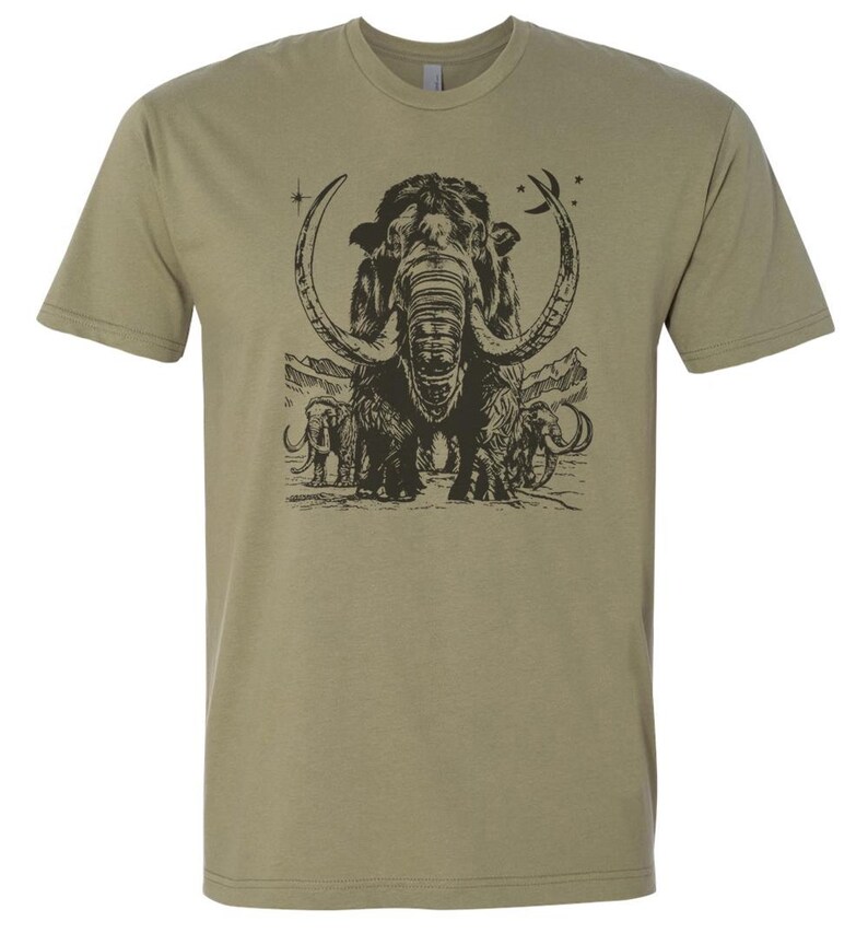 May include: A khaki green t-shirt with a black and white illustration of a woolly mammoth with its tusks curved into a crescent shape. The mammoth is surrounded by smaller mammoths and stars.