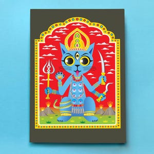 May include: A rectangular art print featuring a blue cat with four arms, a third eye, and a golden crown. The cat holds a trident and blades against a red sky with white clouds and volcanic mountains. The border is yellow with black dots.