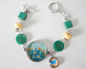 Turquoise Bracelet with Floral Meadow Art Pendant and  Butterfly Charm, Glass Lampwork Beaded Jewellery, Handmade Jewelry Flower Pattern