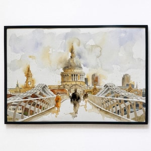 Könnte beinhalten: Gerahmtes Aquarellgemälde des St. Paul's Cathedral in London. Das Kunstwerk zeigt die Kathedrale und eine Brücke mit Menschen, die sie überqueren. Die Farbpalette umfasst Beige-, Grau- und Brauntöne.