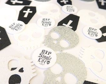 May include: Black and white confetti featuring skulls, crosses, and coffins. The confetti includes the text "RIP Single Life".