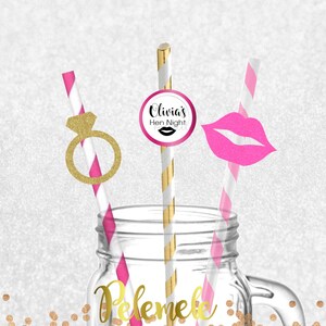 May include: Pink and gold striped straws with decorative toppers for a hen party. The toppers include a gold ring, a pink lip, and a round sticker that says "Olivia's Hen Night".