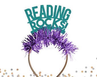 May include: Teal glitter headband with the words "Reading Rocks" and purple tinsel.