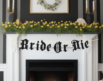 May include: Black and white "Bride or Die" banner with a gothic font hanging above a fireplace. The banner is decorated with small white dots.