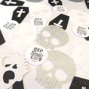 May include: Black and white confetti featuring skulls, crosses, and coffins. The confetti includes the text "RIP Single Life".