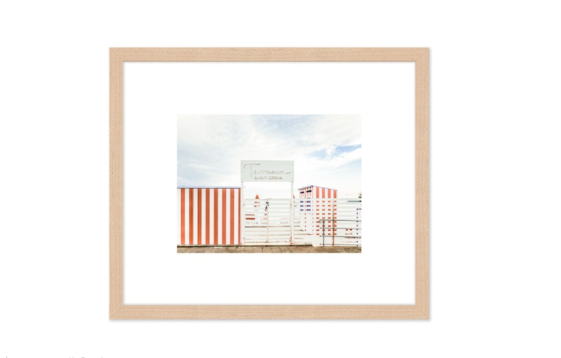 May include: A white gate with a sign that reads "Lido Beach Club" in front of a red and white striped fence.