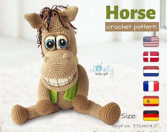 May include: Crocheted horse amigurumi toy with brown fur, green scarf, and blue eyes. The toy is sitting on a white surface. The image includes the text "Horse crochet pattern" and "Size: approx. 37cm/14.5"