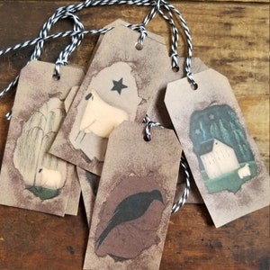 May include: Set of six rustic gift tags with twine. Each tag features a different primitive folk art illustration, including a sheep, a crow, and a farmhouse.