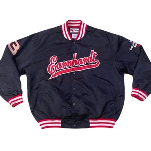 May include: Black satin bomber jacket with red and white accents. Features the name "Earnhardt" in red script across the chest, a "3" on the left sleeve, and "Goodyear Service" on the right sleeve.
