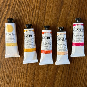 5 tubes of Gamblin Artist Oil Colors. The colors are Naples Yellow, India Yellow, Cadmium Orange, Naples Orange, and Quinacridone Magenta edusite https://edusite.etsy.com