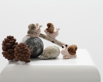 Miniature crochet snail toy. Amigurumi snail. Crochet miniature art.