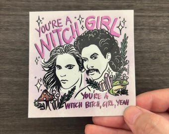 May include: A square sticker featuring a black and white illustration of two people with long hair, one with a mustache. The text reads YOU'RE A WITCH GIRL and YOU'RE A WITCH BITCH, GIRL, YEAH. The design includes a mushroom, crystals, and a frog.