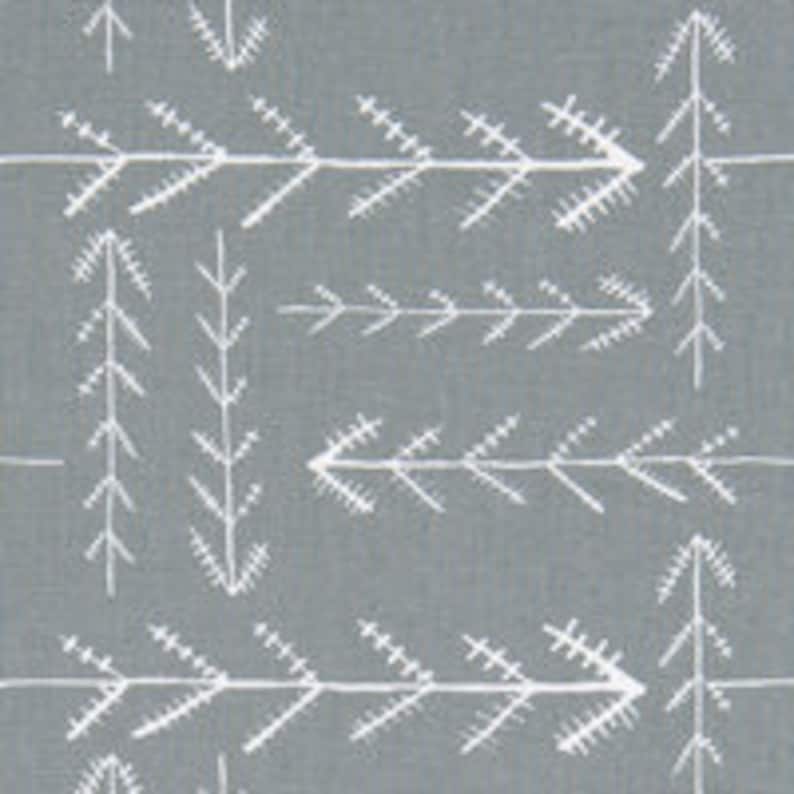 May include: A grey fabric with a white repeating pattern of stylised pine trees and arrows.