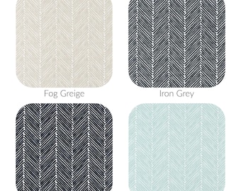 May include: Four fabric swatches with a herringbone pattern. The swatches are in the colors Fog Greige, Iron Grey, Dark Blue, and Snowy Blue.