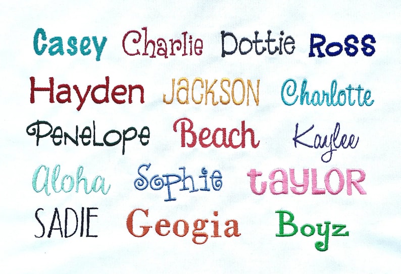 May include: A white fabric background with embroidered names in various colours, including Casey, Charlie, Dottie, Ross, Hayden, JACKSON, Charlotte, Penelope, Beach, Kaylee, Aloha, Sophie, taylor, SADIE, Geogia, and Boyz.