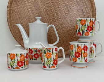 Tetera vintage con diseño floral en naranja y rojo, jarra para leche, azucarero cubierto y 3 tazas con diseño floral en naranja y rojo